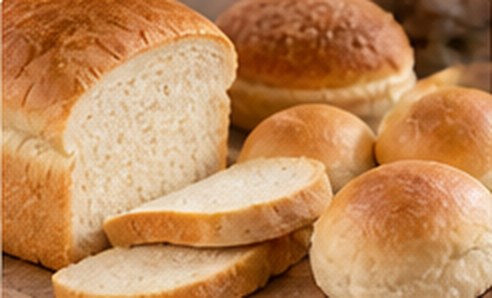 Sliced white loaf and bread rolls
